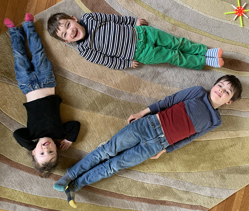 Three children forming a triangle