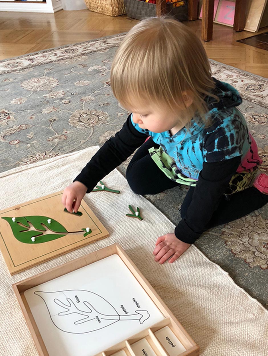 baby putting puzzle piece in block of wood